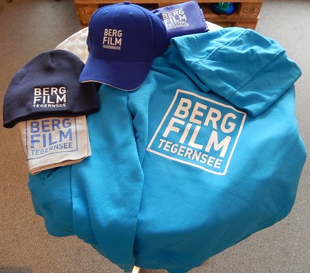 Fanartikel zu Bergfilm Tegernsee: Beanies, Hoodies, Caps, Mikrofaserhandtuch und Sitzkissen